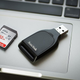Photo of an SD Card next to an SD Card Reader